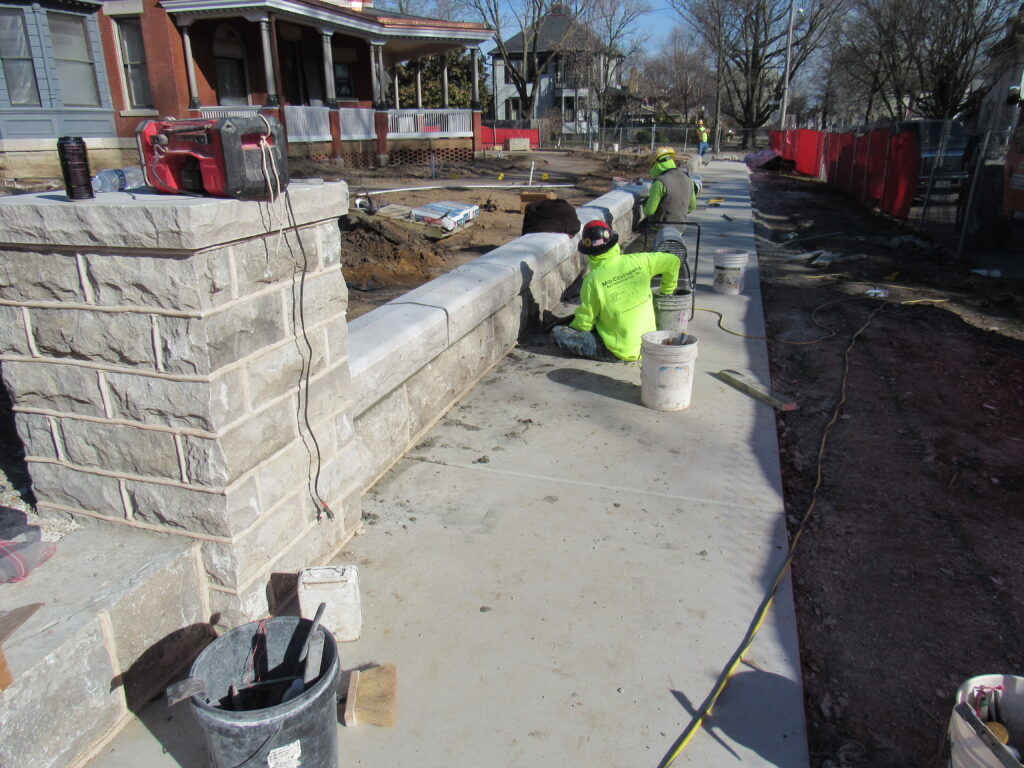 Mason at work constructing a limestone wall