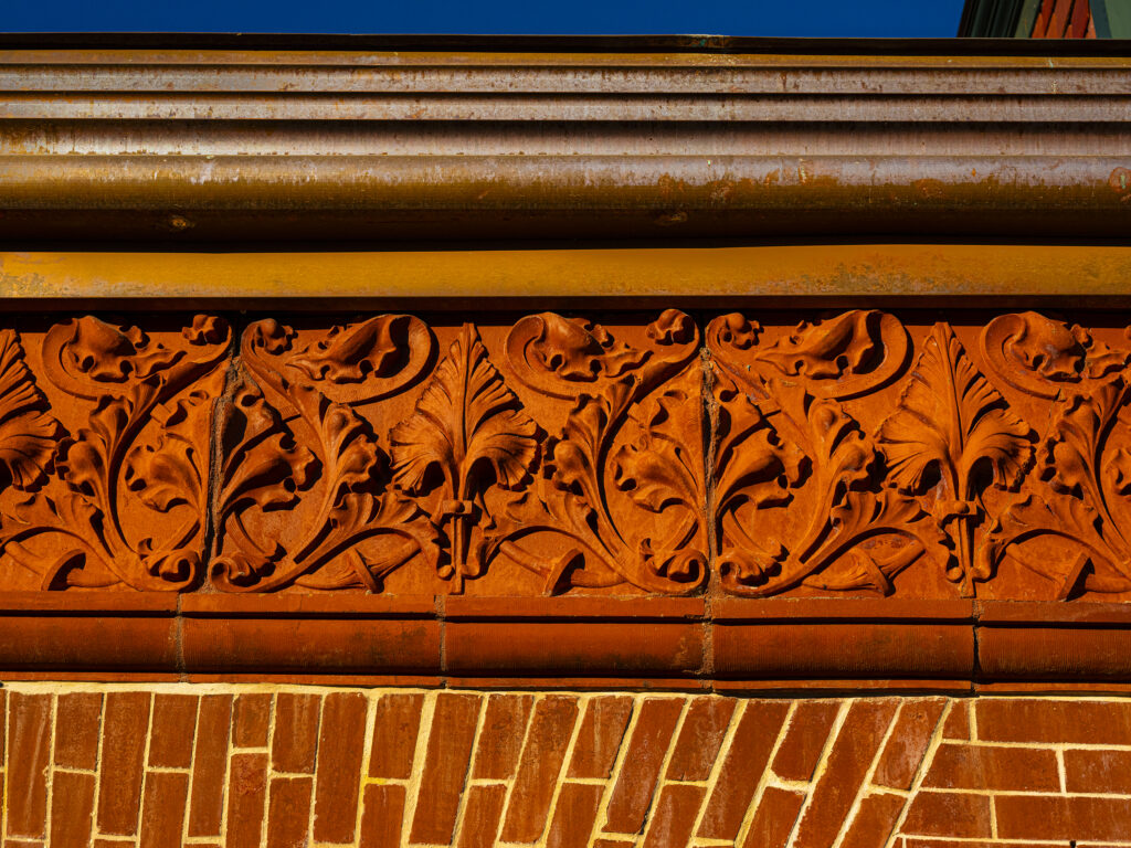 terra-cotta leaf art detail on the facade of the Schifferdecker home