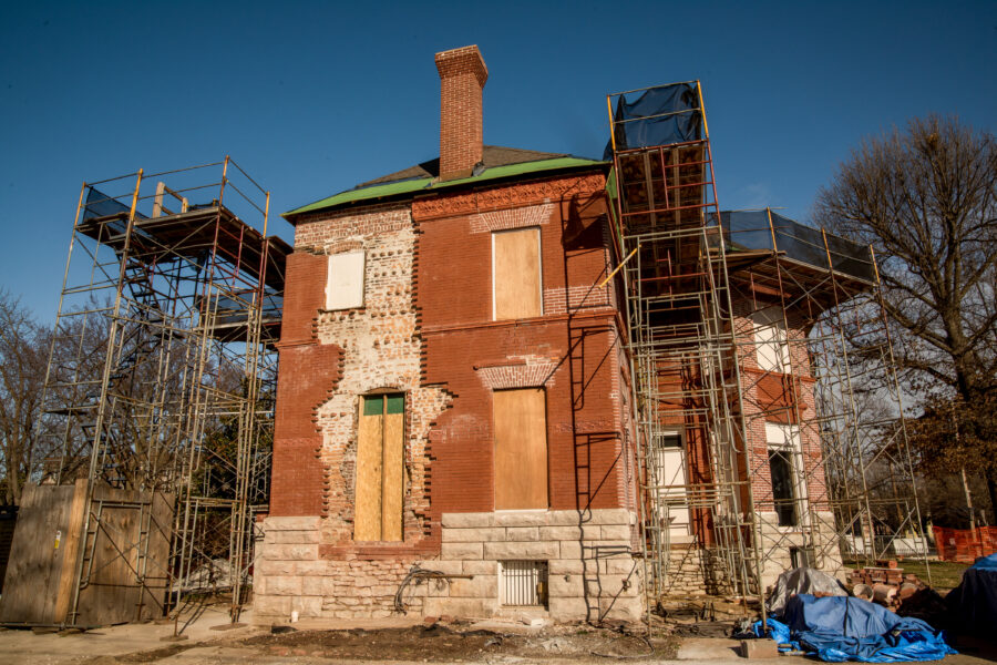 The back of the Schifferdecker home with a portion of the brick removed from the façade.