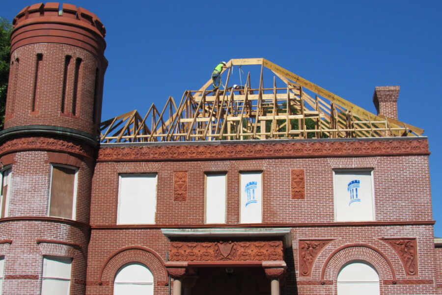 A stick roof structure being reconstructed on the Schifferdecker home