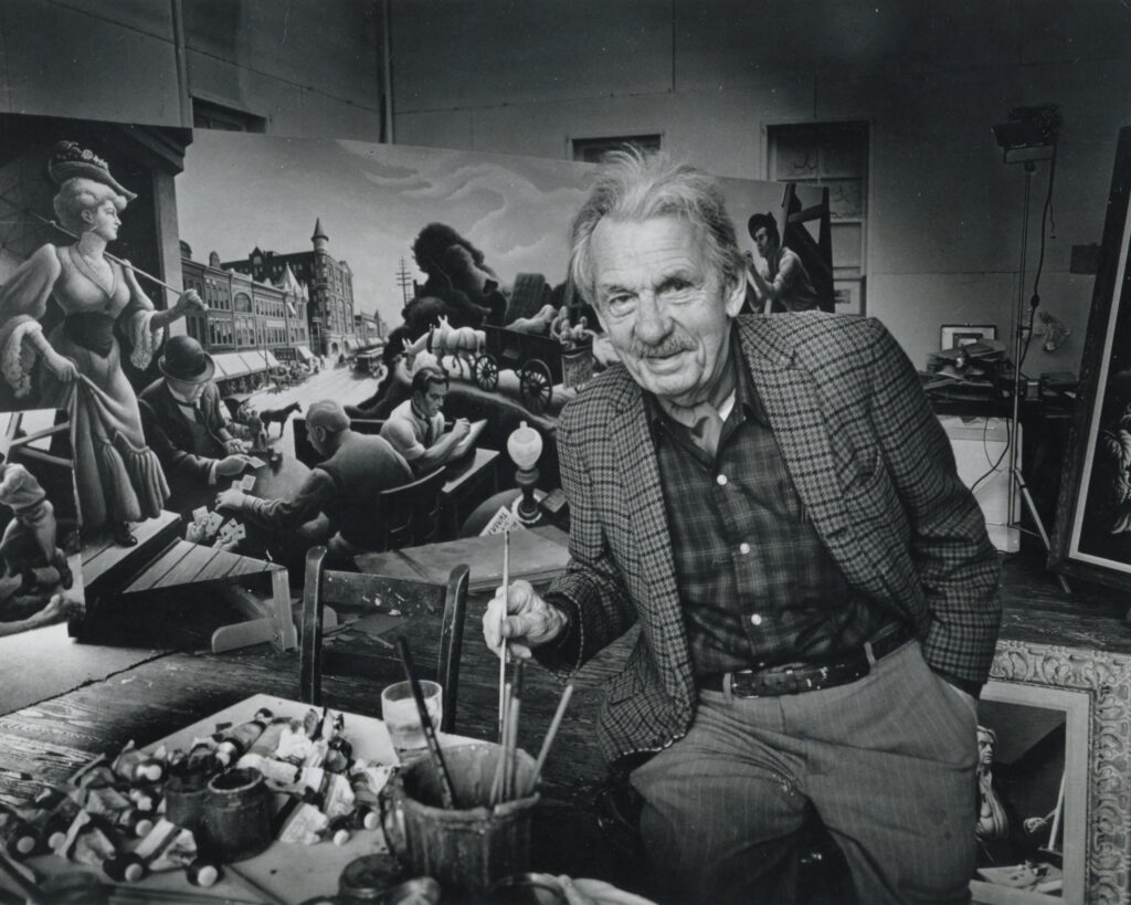 Thomas Hart Benton in his studio in front of the mural "Joplin at the Turn of the Century"