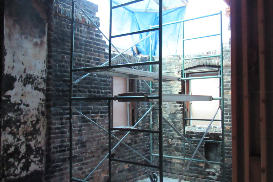 Brick walls showing blackened damage from a 1991 fire