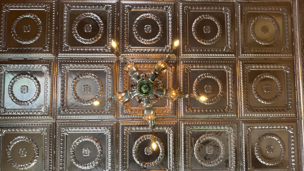 stamped copper ceiling and antique light fixture