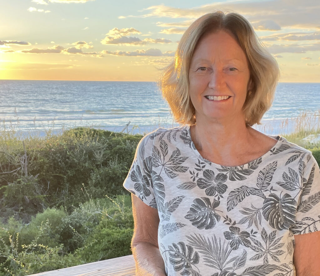 author Judy Stiles with the ocean in the background
