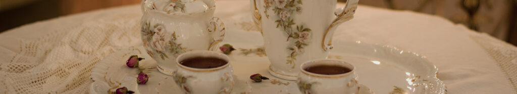 detail of tea service on a table with lace tablecloth