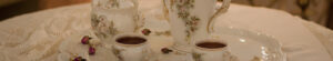 detail of tea service on a table with lace tablecloth