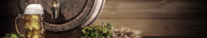 beer barrel with glass of beer in front